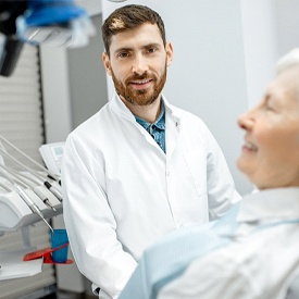 older woman talking to dentist