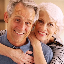 older couple smiling and hugging