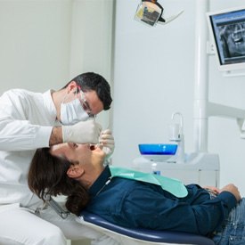 Implant dentist working on a reclined patient