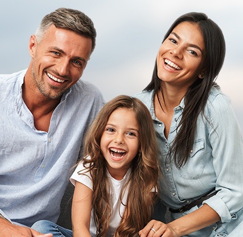 Mother father and daughter smiling together