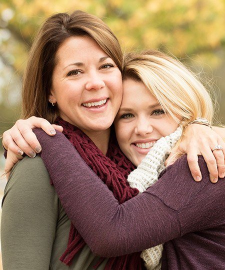 Two women smiling together outdoors