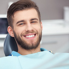 Man in dental chair showing teeth after smile makeover in Wheaton