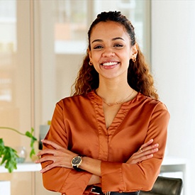 Woman smiling with her arms folded