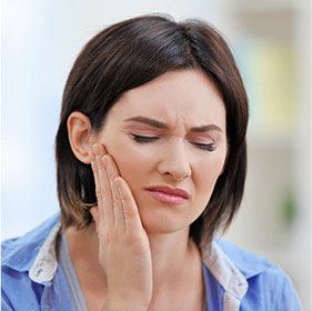 Woman holding jaw in pain