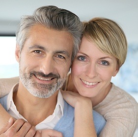 Older man and woman smiling together