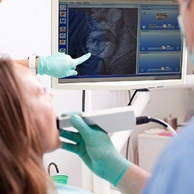 Dentist and patient looking at intraoral photos