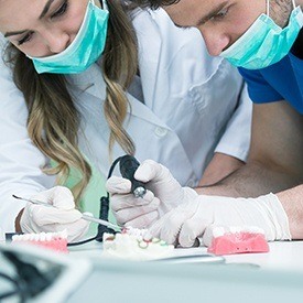 Dental team members creating wax-up model