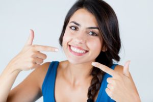 woman pointing to smile