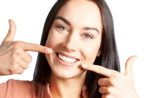 Woman pointing to her straight smile