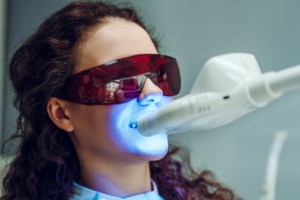 Woman having teeth whitening treatment
