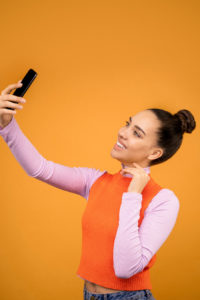 Woman taking a selfie with a cellphone